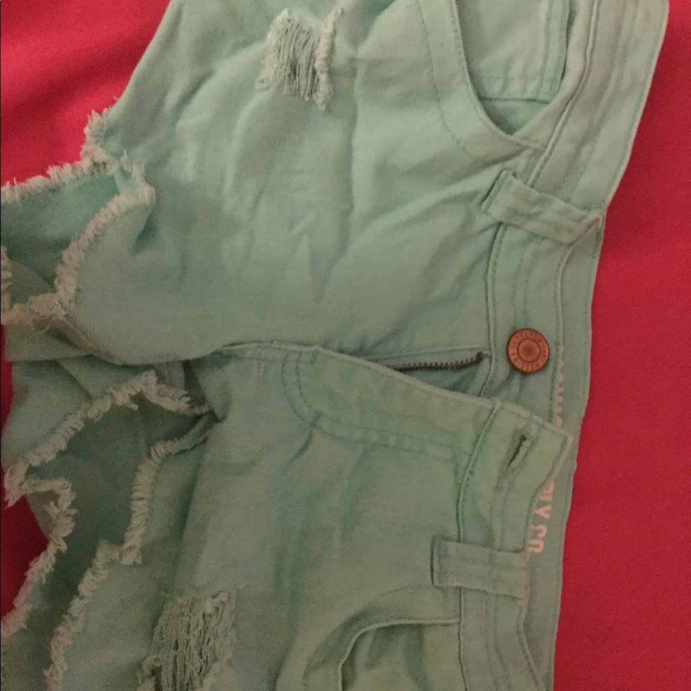 Ripped green shorts